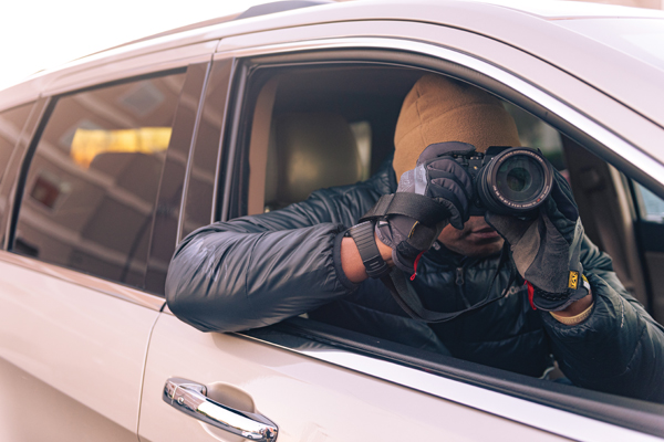 an image of a man in a car with a dslr camera